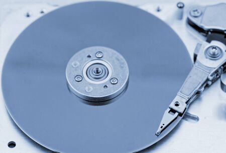Open computer hard drive on white background with blue (HDD, Winchester)の写真素材