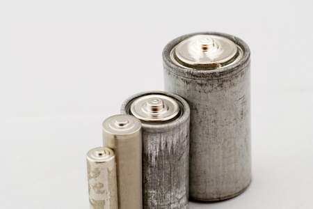 Old grey batteries on white background (aa, aaa, b, c)の写真素材