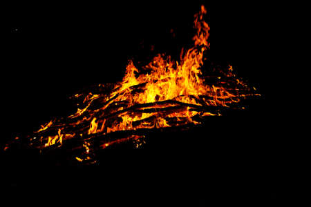 red flames of huge bonfire or campfire as black backgorundの写真素材