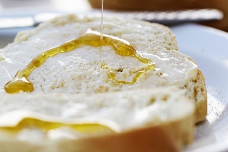 slices of bread with honey and butterの写真素材