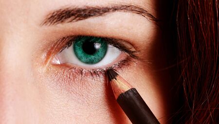 beautiful woman wearing makeup for eyes with eyelinerの写真素材