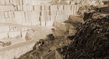 Detail of huge Thassos white marble quarry (mine) with grabber sepiaの写真素材