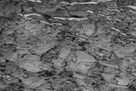 grey abstract background of wavy water surfaceの写真素材