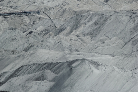 Coal mining in an open pit with huge industrial machineの写真素材