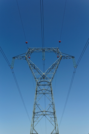Detail of electricity pylon against blue sky の写真素材