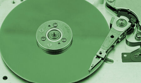 Open computer hard drive on white background with green (HDD, Winchester)の写真素材