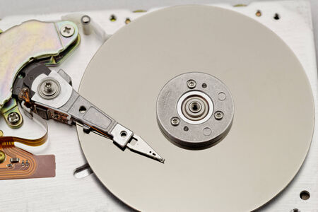 Open computer hard drive on white background with spezial color filter (HDD, Winchester)の写真素材