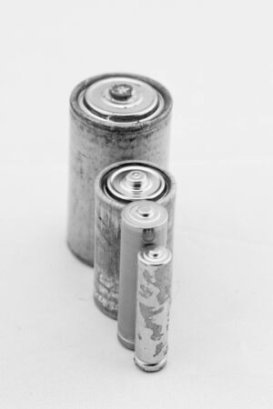 Old grey batteries on white background (aa, aaa, b, c)の写真素材