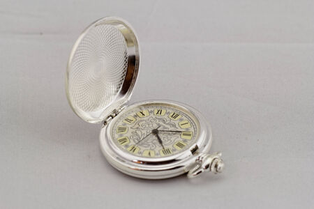 Part of a antique mechanical pocket watch on white backgroundの写真素材