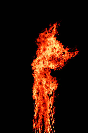 red flames of huge bonfire or campfire as black backgorundの写真素材