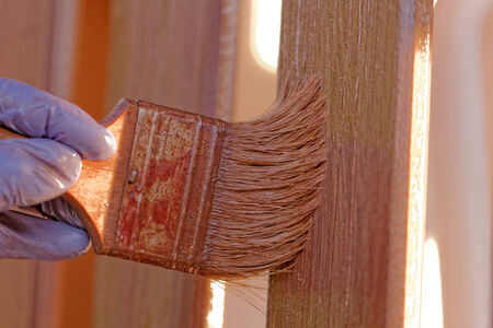 planks fence dyeing with brown paint and brushの写真素材
