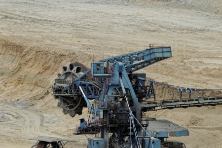 Coal mining in an open pit with huge industrial machineの写真素材