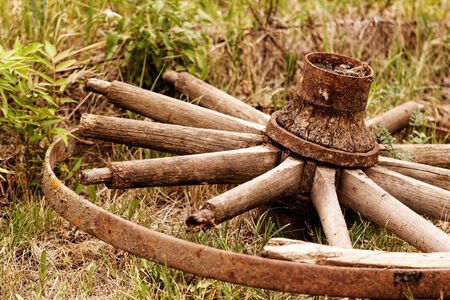 old broken wagon wheel in the field (chariot wheel)の写真素材