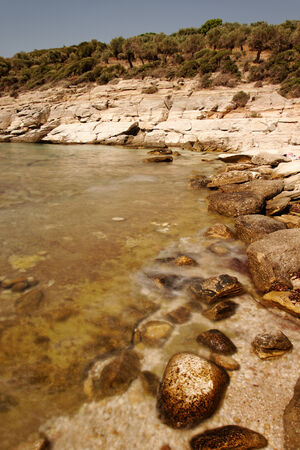 rocky beach with turquoise sea in greece thassos islandの写真素材