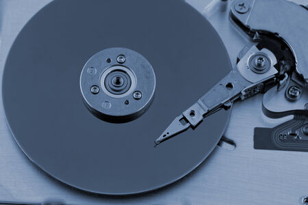Open computer hard drive on white background with blue (HDD, Winchester)の写真素材
