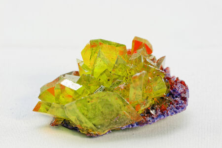 Close up picture about a crystal with emerald color on white background (green crystal)の写真素材