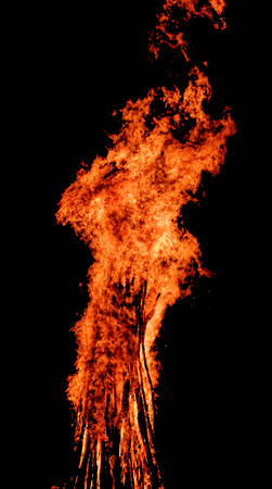 red flames of huge bonfire or campfire as black backgorundの写真素材