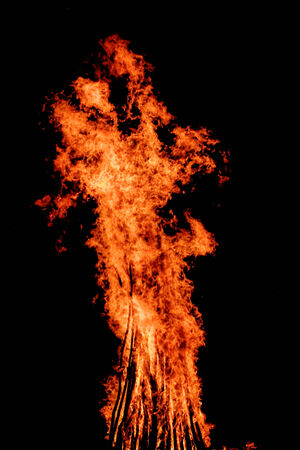 red flames of huge bonfire or campfire as black backgorundの写真素材