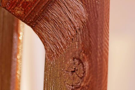 planks fence dyeing with brown paint and brushの写真素材