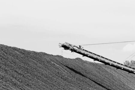 Coal mining in an open pit with huge industrial machineの写真素材