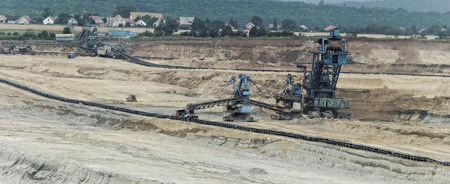 Coal mining in an open pit with huge industrial machineの写真素材
