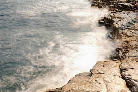 the rocky beach breaks the huge wavesの写真素材