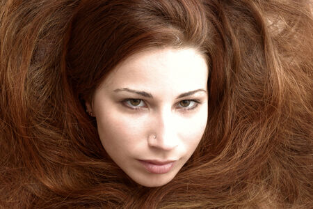 Beautiful young woman with long hair posingの写真素材
