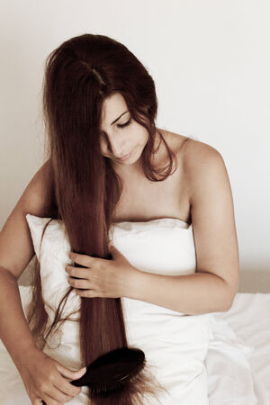 Beautiful young woman with long hair posingの写真素材