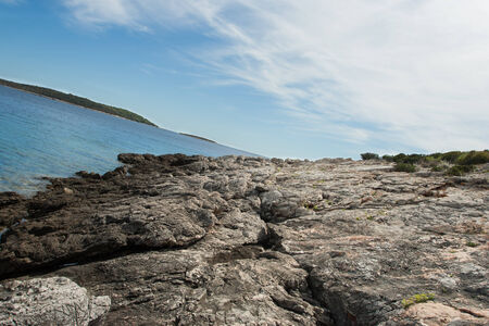 Photo of a rock on the beach の写真素材