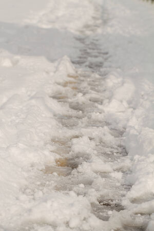 Close up photo of a trodden path in the snowの写真素材