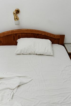 Photo of a bed in the hotel roomの写真素材