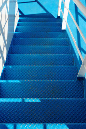 Photo of a blue industrial staircase in the ship 