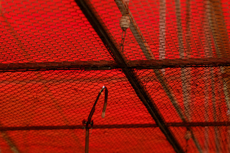 Photo of a truss roof with red backgroundの写真素材