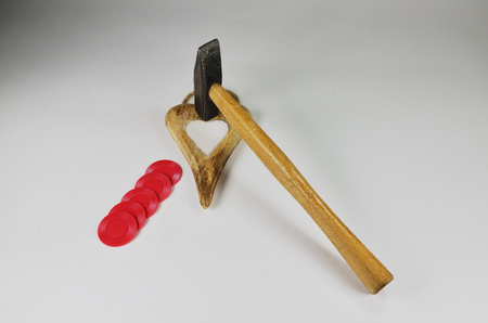 Steel hammer, wooden heart with a stone center and a few drops of blood.の写真素材