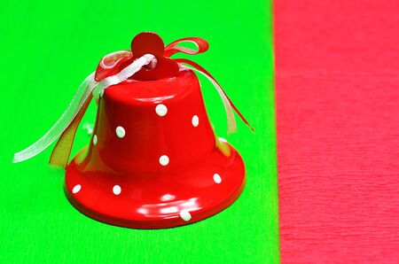 Red bell on a green and red backgroundの写真素材