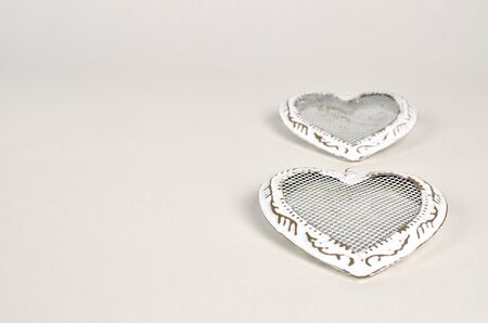 Two white hearts on a light background. Only the first heart is sharp.の写真素材