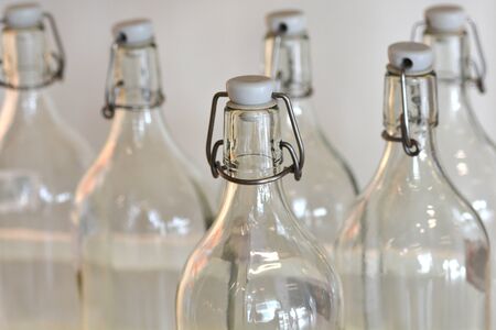 Detail of six empty glass bottles