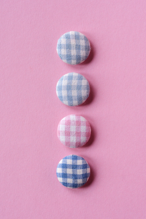 Four buttons in pastel pink
