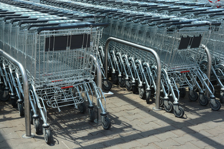 Lots of parked silver metal shopping carts
