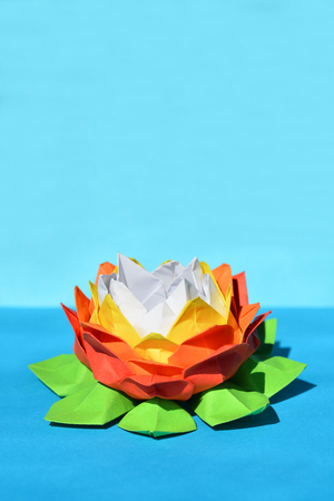 Colorful origami paper water lily on blue backgroundの写真素材