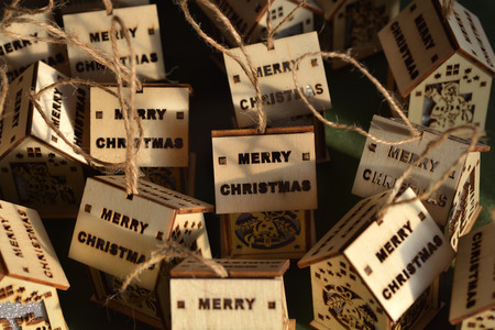 Wooden Christmas ornaments in shape of house with Merry Christmas wording on the roofの写真素材