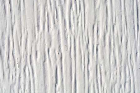 Detail of a  wall with cracked white paint
