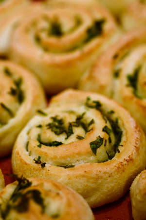 Close up of a tray with baked herb swirl bunsの写真素材