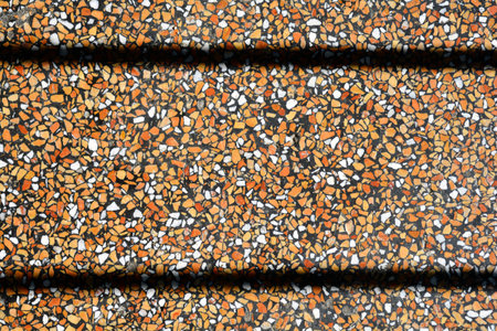 Detail of polished concrete white, brown and black floor with parallel shadows