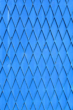 Detail of diamond shaped fence painted in blueの写真素材
