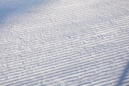 Detail of a ski slope with traces of ratrak in snowの写真素材