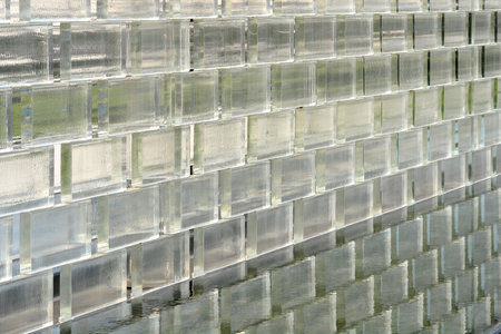 Glass brick wall with reflection in water