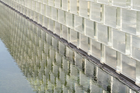 Glass brick wall with reflection in waterの写真素材