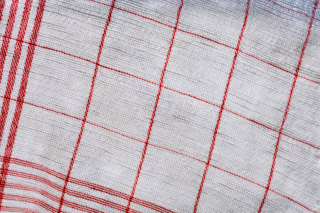 Close-up detail of a white kitchen cloth with red stripes