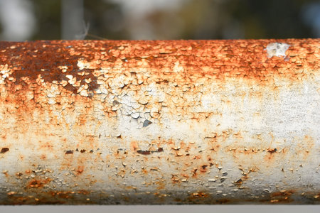 Detail of a rusty pipe with peeling and cracked white paintの写真素材